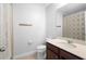 Neutral bathroom with a modern vanity, tile flooring, and shower featuring shower curtain at 2202 Garden Belle Dr, Clermont, FL 34711