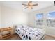 Cozy bedroom featuring a ceiling fan, natural light from two windows and neutral paint at 2202 Garden Belle Dr, Clermont, FL 34711