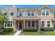Charming home featuring a cozy front porch and well-maintained landscaping at 2202 Garden Belle Dr, Clermont, FL 34711