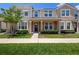 Inviting townhome showcasing well-maintained landscaping, a cozy porch, and a welcoming entryway at 2202 Garden Belle Dr, Clermont, FL 34711
