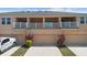 Home exterior showcasing attached garages, balconies, and lush landscaping at 2202 Garden Belle Dr, Clermont, FL 34711