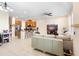 Inviting living room featuring an open layout with a kitchen, tile floors, and modern decor at 2202 Garden Belle Dr, Clermont, FL 34711