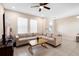 Comfortable living room with a large sectional sofa, tile flooring, and natural light at 2202 Garden Belle Dr, Clermont, FL 34711