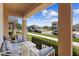 Relaxing covered porch with comfortable seating and a view of the quiet neighborhood street at 2202 Garden Belle Dr, Clermont, FL 34711