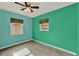 Empty bedroom with ceiling fan, and bright green and blue walls at 2209 Hutchinson Ave, Leesburg, FL 34748