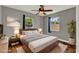 Cozy bedroom featuring hardwood floors, soft natural lighting, and two windows at 2209 Hutchinson Ave, Leesburg, FL 34748