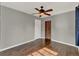 Bedroom with gray walls, wood floor, ceiling fan, closet, and natural light at 2209 Hutchinson Ave, Leesburg, FL 34748