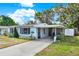 Charming single-story home with a well-maintained lawn, inviting entrance, and covered parking at 2209 Hutchinson Ave, Leesburg, FL 34748