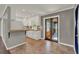 Cozy kitchen featuring white cabinets, tiled countertops, backsplash, and adjacent eating area at 2209 Hutchinson Ave, Leesburg, FL 34748