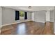 Spacious living room with hardwood flooring, neutral paint, and a large window at 2209 Hutchinson Ave, Leesburg, FL 34748