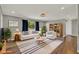 Bright living room with hardwood floors, neutral walls, stylish furnishings, and a large window at 2209 Hutchinson Ave, Leesburg, FL 34748