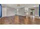 Spacious living room with wood floors, gray walls, and bright, open layout at 2209 Hutchinson Ave, Leesburg, FL 34748