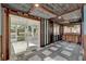 Home office with patterned ceiling, wood paneled walls, and view to screened lanai at 2209 Hutchinson Ave, Leesburg, FL 34748