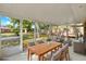 Inviting screened patio featuring a wood dining table and comfortable lounge seating, perfect for relaxation at 2209 Hutchinson Ave, Leesburg, FL 34748