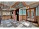 Sunroom with patterned ceiling, wood paneled walls, and view to screened lanai at 2209 Hutchinson Ave, Leesburg, FL 34748