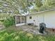 Backyard featuring a screened porch and large tree at 2401 Greenlaw Ct, Leesburg, FL 34788