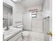 A bright bathroom featuring a skylight, walk-in shower, bathtub, and modern finishes at 2401 Greenlaw Ct, Leesburg, FL 34788