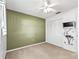 A bedroom featuring carpet flooring, a ceiling fan, closet space, and an entertainment center at 2401 Greenlaw Ct, Leesburg, FL 34788