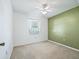A bright bedroom featuring carpeted flooring, a large window, and a ceiling fan at 2401 Greenlaw Ct, Leesburg, FL 34788