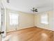 Empty bedroom with hardwood floors, a ceiling fan, and a window providing plenty of natural light at 2401 Greenlaw Ct, Leesburg, FL 34788