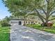 Charming single-story home with a well-maintained front yard and attached two car garage at 2401 Greenlaw Ct, Leesburg, FL 34788