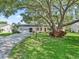 Charming single-story home with a large front yard and mature tree providing ample shade at 2401 Greenlaw Ct, Leesburg, FL 34788