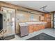 Garage featuring custom cabinets, counter tops, and access to the home at 2401 Greenlaw Ct, Leesburg, FL 34788