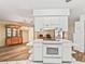 Kitchen cooktop and island are connected with a view of the dining room and wooden hutch at 2401 Greenlaw Ct, Leesburg, FL 34788