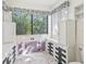 Laundry room with cabinets, tile accent wall, plus a view of the back yard through the window at 2401 Greenlaw Ct, Leesburg, FL 34788