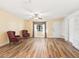 Cozy living room with wood flooring, built in shelves and natural light from a nearby window at 2401 Greenlaw Ct, Leesburg, FL 34788