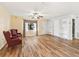 Cozy living room with wood flooring, built in shelves and natural light from a nearby window at 2401 Greenlaw Ct, Leesburg, FL 34788