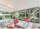Screened porch with a large tree view and outdoor seating at 2401 Greenlaw Ct, Leesburg, FL 34788