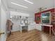 Bright sewing room featuring custom cabinets, counter tops, and hardwood floors at 2401 Greenlaw Ct, Leesburg, FL 34788