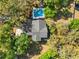 An aerial view of a house with a refreshing backyard pool, all nestled among the trees at 25541 Troon Ave, Sorrento, FL 32776