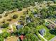 Aerial view showcasing the neighborhood's lush landscaping, streets, and nearby homes at 25541 Troon Ave, Sorrento, FL 32776