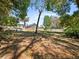 Spacious backyard featuring a fire pit, Adirondack chairs and mature trees at 25541 Troon Ave, Sorrento, FL 32776