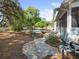 Backyard view featuring a stone path, pool, deck, and mature landscaping on an oversized lot at 25541 Troon Ave, Sorrento, FL 32776