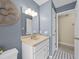 Bathroom with a light colored vanity, mirror, and gray walls at 25541 Troon Ave, Sorrento, FL 32776