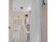 Bright bathroom features a shower and curtain, soaker tub, white tile and a window at 25541 Troon Ave, Sorrento, FL 32776