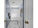 Bathroom features a shower and white vanity with a patterned tile floor at 25541 Troon Ave, Sorrento, FL 32776