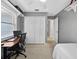 Bedroom with a desk, closet, window, and neutral carpet creates a cozy and functional space at 25541 Troon Ave, Sorrento, FL 32776