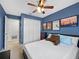 Blue bedroom with carpet, bed and closet with door leading to the bathroom at 25541 Troon Ave, Sorrento, FL 32776