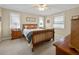 Bedroom with a wooden bed frame, two bedside tables and a large dresser at 25541 Troon Ave, Sorrento, FL 32776
