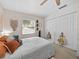 This bedroom features a large closet and cozy neutral decor with a comfy bed at 25541 Troon Ave, Sorrento, FL 32776