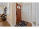 Inviting entryway featuring hardwood floors, a decorative rug, and convenient closet space for storage at 25541 Troon Ave, Sorrento, FL 32776