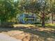 Charming two-story home with a cozy front porch and mature landscaping at 25541 Troon Ave, Sorrento, FL 32776