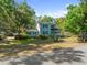 Charming two-story home with a cozy front porch and well-manicured lawn at 25541 Troon Ave, Sorrento, FL 32776