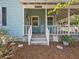 Inviting front porch with rocking chairs and a welcoming entrance, perfect for relaxing at 25541 Troon Ave, Sorrento, FL 32776