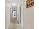 Hallway with neutral walls and carpet, doors, and ceiling lights at 25541 Troon Ave, Sorrento, FL 32776
