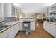 Kitchen flows to dining area and sitting room with fireplace at 25541 Troon Ave, Sorrento, FL 32776